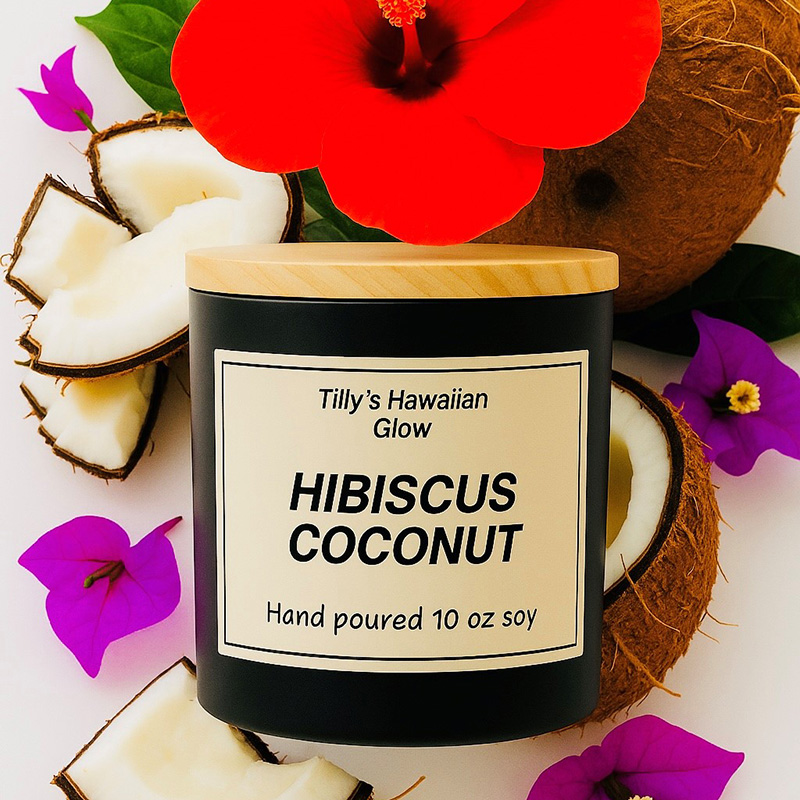 Tilly's Hawaiian Glow Hibiscus Coconut 10 oz hand-poured black soy candle with wooden lid, surrounded by a red hibiscus flower, coconuts, and purple bougainvillea.
